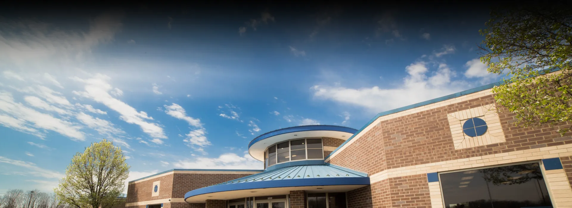 Exterior of the front entrance at the YMCA at the Heights on a sunny day