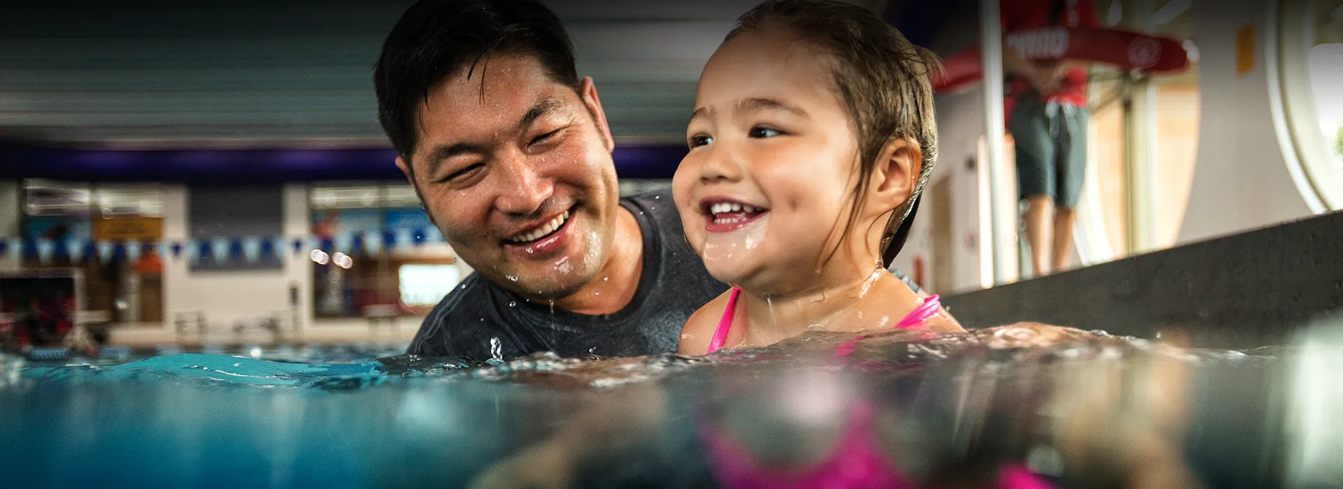 Dad with daughter in swimming pool