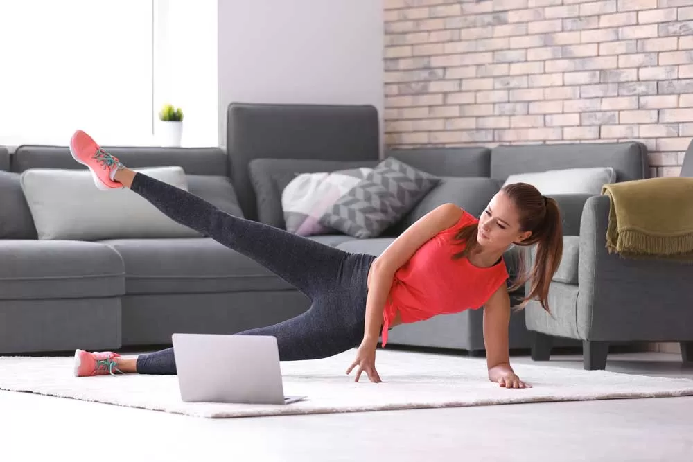 A woman working out from home