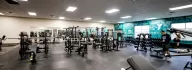 large fitness room at the Xenia YMCA with weight benches, barbells, and free weights