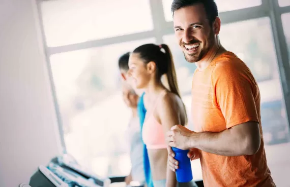 Man smiling while walking on a treadmill