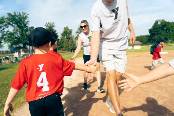 Youth Baseball Teams high five after game