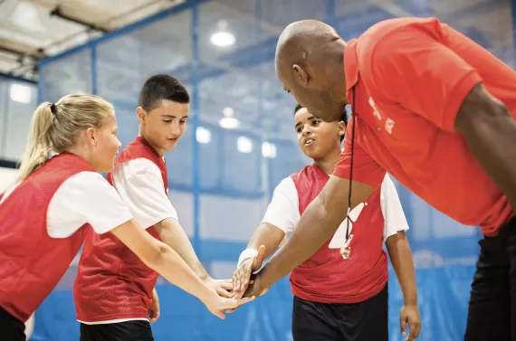 A volunteer coach with his YMCA Youth Basketball team