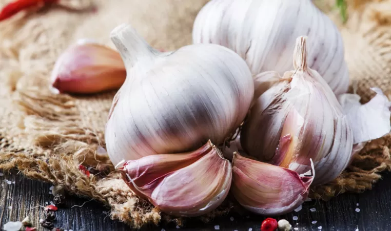 Garlic cloves sitting on a counter in a kitchen