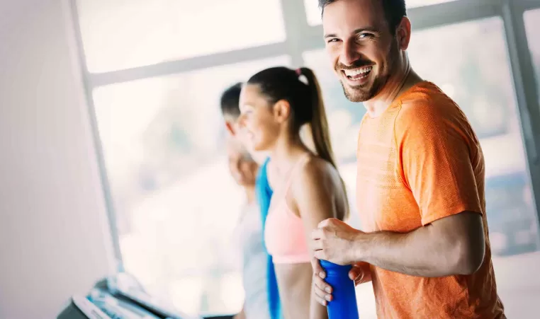 Man smiling while walking on a treadmill
