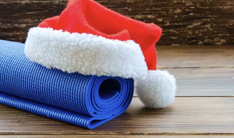A Santa hat sitting on top of a yoga mat