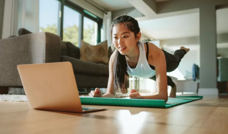 Woman working out in her home