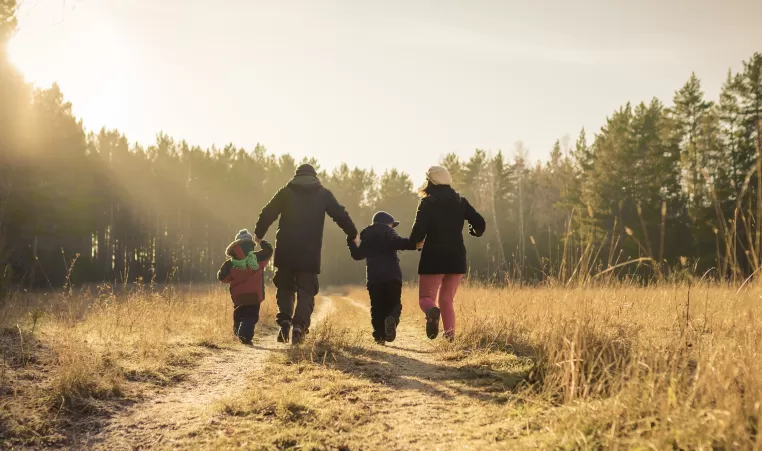 happy family walking on country road