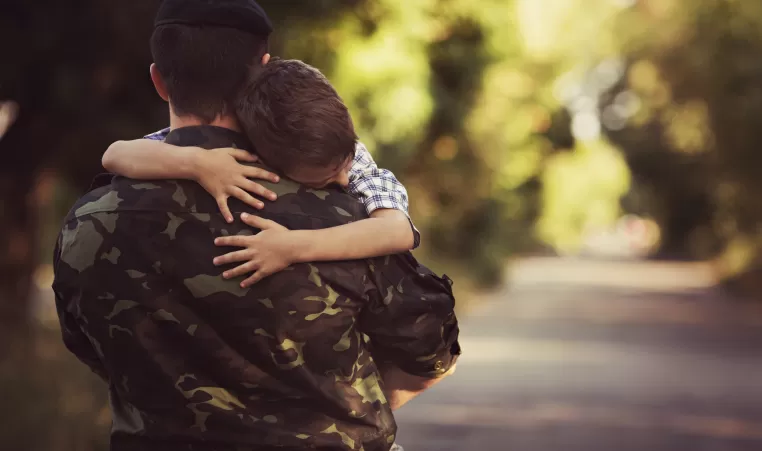 Woman and soldier in a military uniform say goodbye