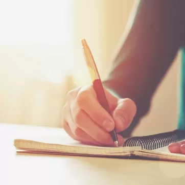 A man writing in his notebook