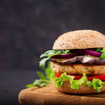 A turkey burger on wheat bread with vegetables