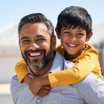 Father and son smiling together