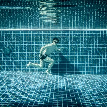 Man runs underwater swimming pool