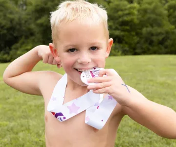 A boy with his medal at the Strong Kids Triathlon