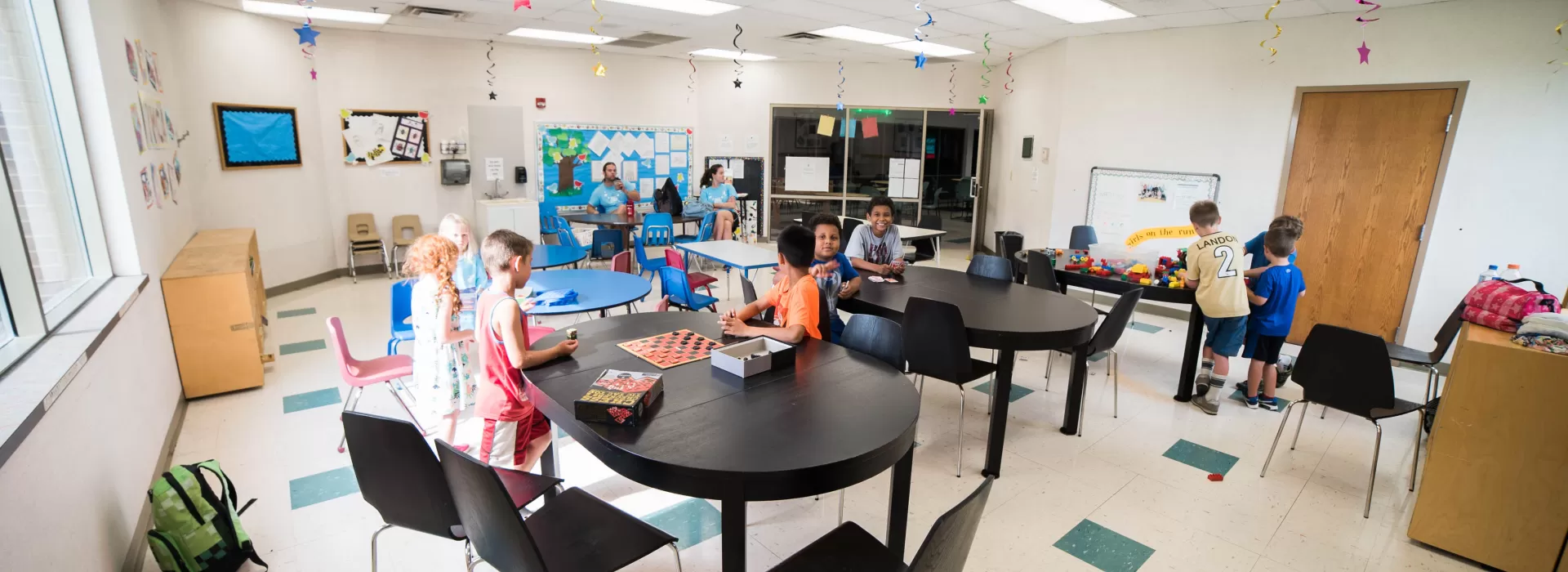 Child care room where kids are playing games and doing crafts at the Coffman YMCA