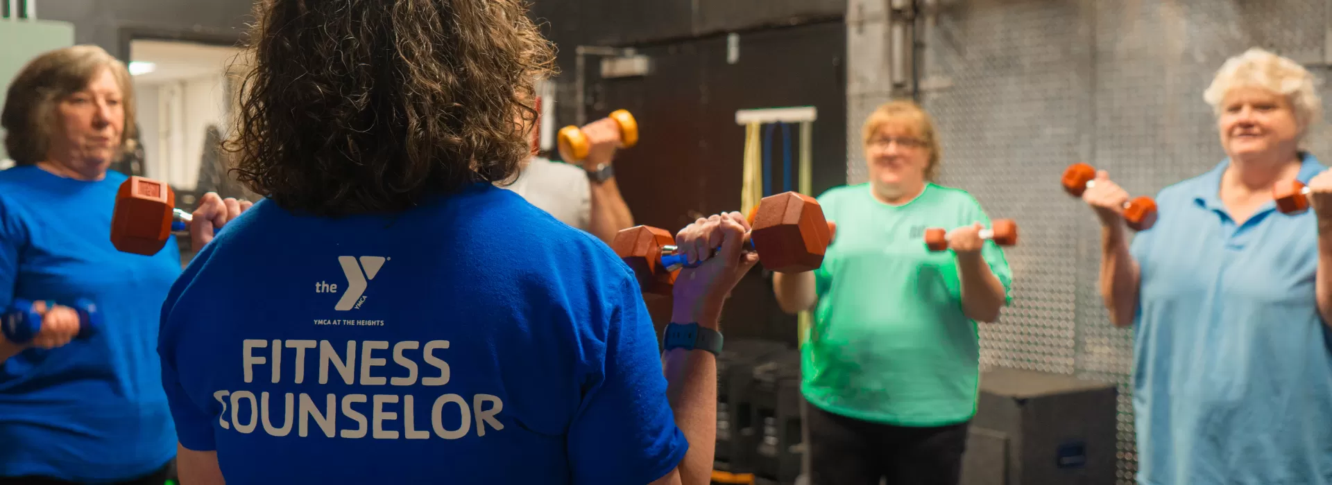 Fitness Counselor with group lifting weights