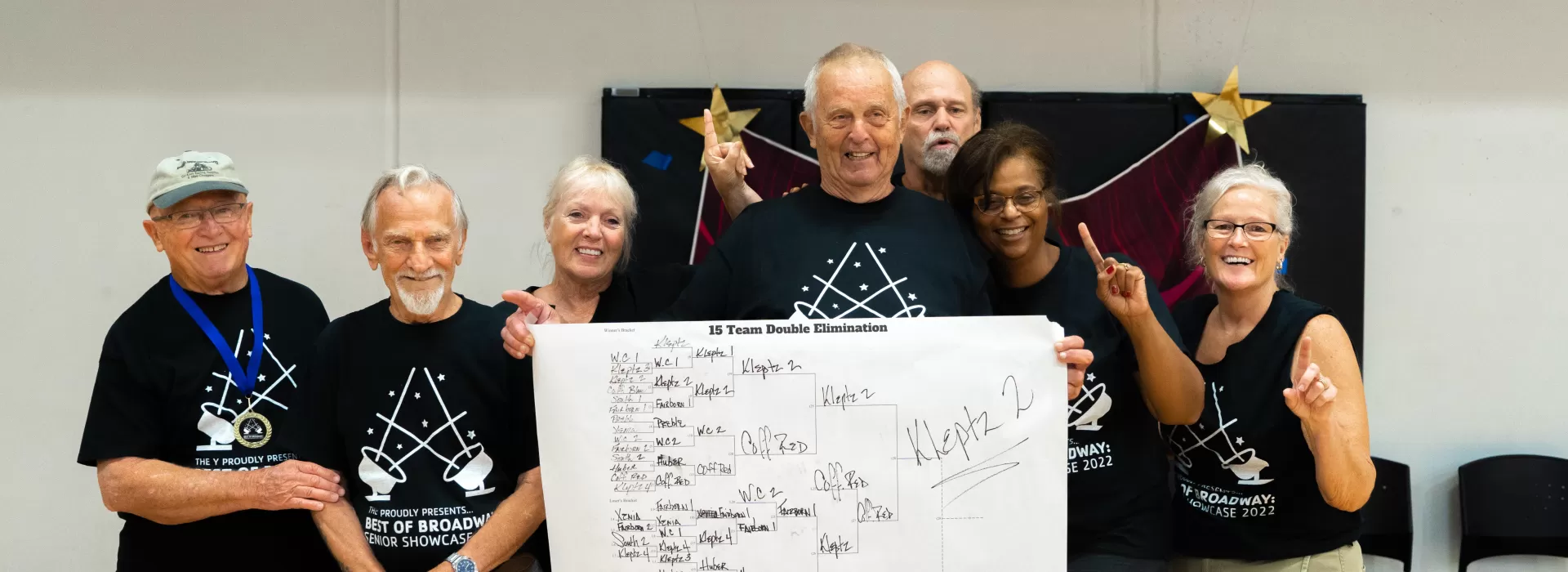 Senior group holding winning bracket