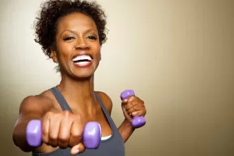A happy women working out with weights